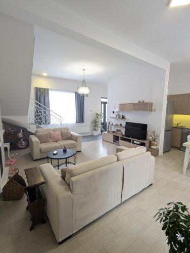 a living room with two couches and a table at House in Gardos in Zemun