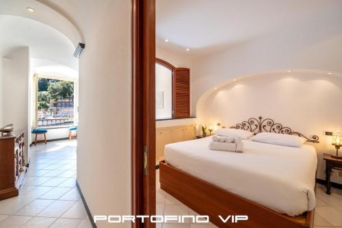 a bedroom with a large white bed in a room at Greca by PortofinoVip, Seaview, AC in Portofino