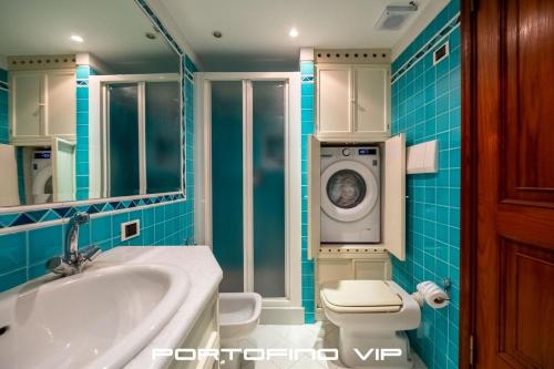 a bathroom with a toilet and a washing machine at Greca by PortofinoVip, Seaview, AC in Portofino