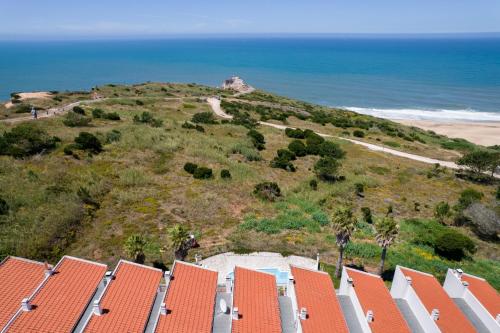 an aerial view of a beach with houses and the ocean at Nativo Big Wave Front Row - 1BR in Nazaré