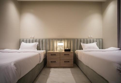 two beds sitting next to each other in a room at Luxury One-Bedroom Apt AlRimal-3 in Riyadh