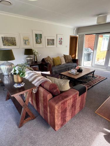 a living room with a couch and a table at Stay Cardrona Wanaka in Cardrona
