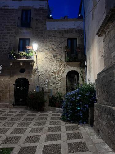 an old stone building with a courtyard at night at Villa Mamma Francesca in Salemi