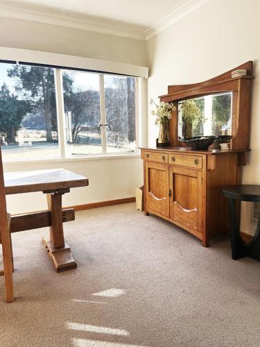 a room with a table and a large window at Stay Cardrona Wanaka in Cardrona