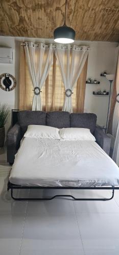 a large bed in a bedroom with curtains at Las Julies's Apartment in Arenales
