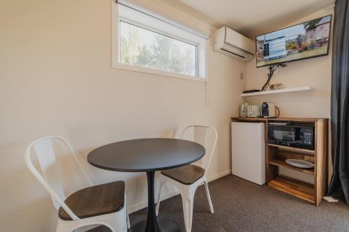 a small kitchen with a table and chairs in a room at Orion Suite - Compact Stay with Essentials in Lake Tekapo
