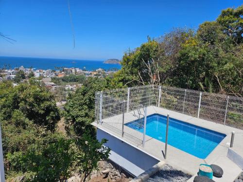 a house with a swimming pool on top of a hill at Las Cabañas del Tio Lalo in Rincon de Guayabitos