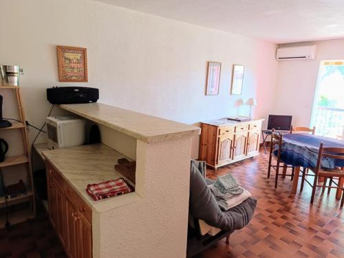 - un salon avec un comptoir et une salle à manger dans l'établissement Coquet appartement avec piscine à 200m de la plage, à Bandol