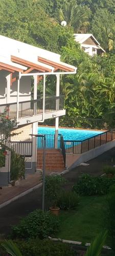a house with a swimming pool in front of it at Detente Caraïbes in Le Gosier