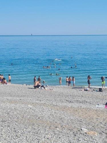 a group of people playing in the water at the beach at Royal Studio Massena in Nice