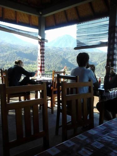 a group of people sitting at a table with a view at One Homestay and Warung in Munduk