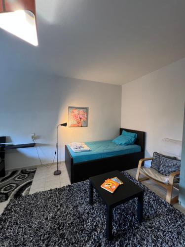 a living room with a bed and a table at John & Jo Apartment! in Kastoria