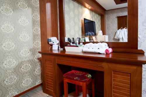 a bathroom with a vanity with a large mirror at Galleria Hotel in Andong