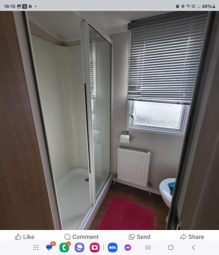 a bathroom with a shower stall and a toilet at Spruce ridge 20 in Filey