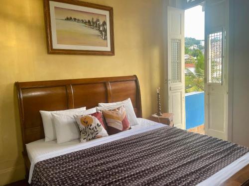 a bedroom with a bed with pillows and a window at Panorama Inn in Rio de Janeiro