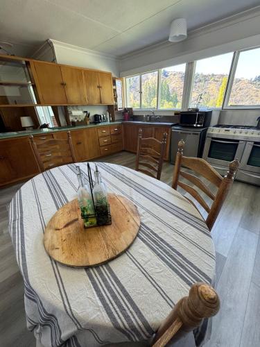 a table in a kitchen with a tableablish at Stay Cardrona Wanaka in Cardrona