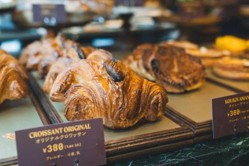 a display of croissants and other pastries in a bakery at Hotel Vintage Tokyo Meguro Fudomae in Tokyo
