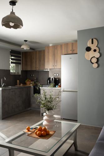 a kitchen with a glass table and a white refrigerator at Ethos Retreat, Luxury Villas in Areopolis