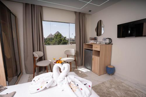 a hotel room with a bed with white towels on it at Quantum Pyramids View INN in Cairo