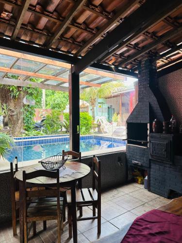 a patio with a table and chairs and a pool at Pousada Núcleo da Serra in Serra do Cipo