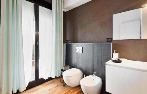 a bathroom with a white toilet and a sink at La Rosa del Golfo dei Poeti in La Spezia
