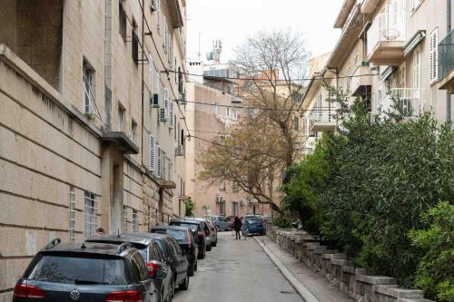 a street with cars parked on the side of a building at Apartment The Charm in Split