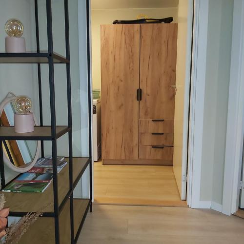 a hallway with a wooden door in a room at Experience unique Faroe Islands holiday home by the sea with great views, fully equipped kitchen and reliable Wi-Fi in Norðragøta