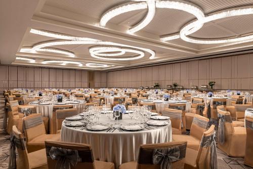 a large banquet hall with tables and chairs at Dusit Thani Residence Davao in Davao City