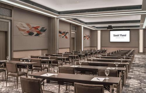 a room with tables and chairs and a projection screen at Dusit Thani Residence Davao in Davao City