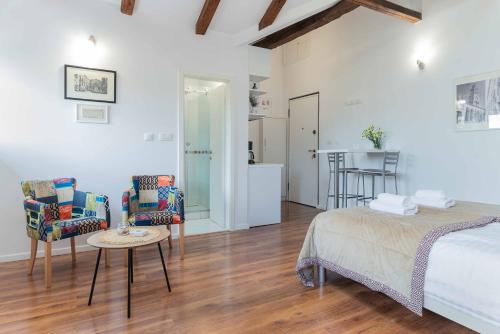 a bedroom with a bed and two chairs and a table at Apartment The Charm in Split