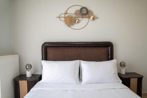 a bedroom with a bed with white sheets and a lamp at Nireas Blue Balcony by Raise in Áno Váthia