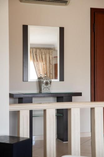 a mirror above a console table in a room at Nireas Blue Balcony by Raise in Áno Váthia