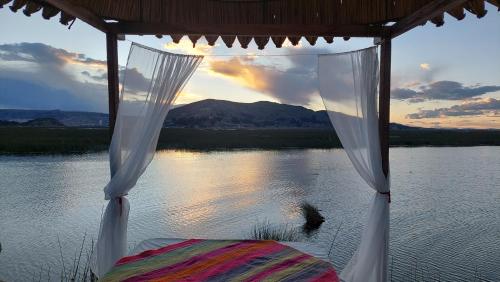 a view of the water from a bed in a tent at Uros Lodge Perú in Puno