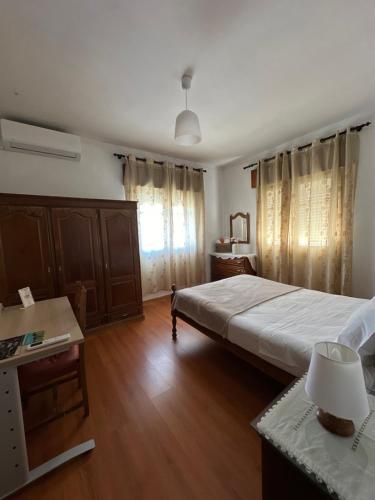 a bedroom with a large bed and a wooden floor at Alojamento local Os Maias in Mirandela