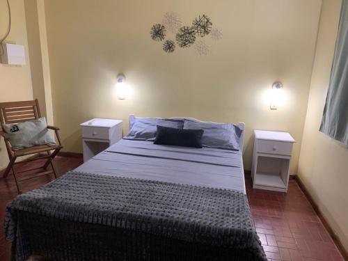 a bedroom with a large bed with two night stands at Yvoty miní in Puerto Iguazú