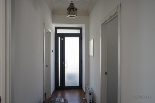 a hallway with a glass door and a window at 12 Casa d'Avó in Albergaria-a-Velha