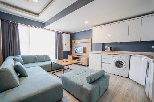 a living room with a couch and a table at Centrum Residence in Ankara
