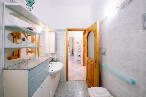 a bathroom with a sink and a toilet in it at Infinity Experience Casa Vacanza Incantevole con Terrazzo in Scala