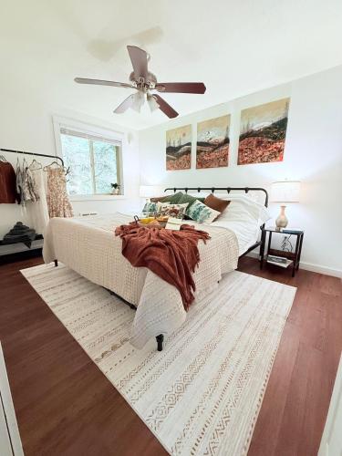 a bedroom with a bed and a ceiling fan at Enchanting Private Forest Retreat near Mt Rainier in Mineral
