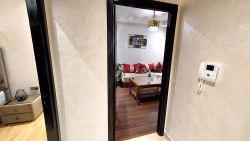 a view of a living room from a hallway at luxury apartment of 80m2 opposite HASSAN 2 MOSQU and SEA , near downtwn from family , INTERDIT COUPLES ARAABIC NON MARIÈ, FORBIDDEN UNMARRIED ARAABIC COUPLES , basement car park FREE in Casablanca