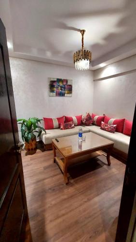 a living room with a couch and a coffee table at luxury apartment of 80m2 opposite HASSAN 2 MOSQU and SEA , near downtwn from family , INTERDIT COUPLES ARAABIC NON MARIÈ, FORBIDDEN UNMARRIED ARAABIC COUPLES , basement car park FREE in Casablanca