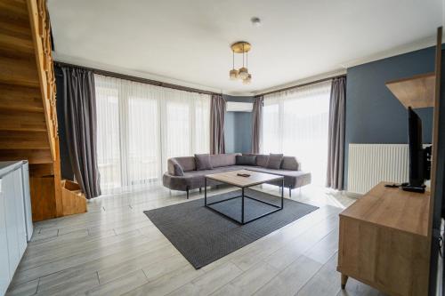 a living room with a couch and a table at Centrum Residence in Ankara