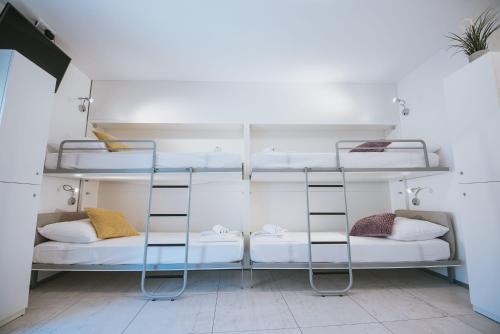 a room with two bunk beds in a room at Avis Hotel in Novalja