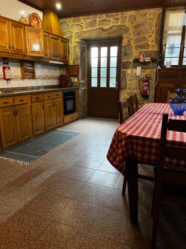 a kitchen with a table with a table cloth on it at Casa da Venda in Covide
