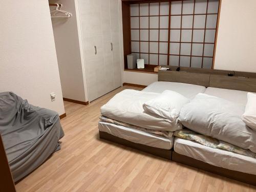 Katil atau katil-katil dalam bilik di Guest House Tomimori