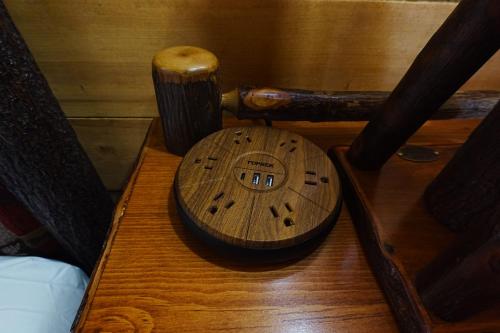 a wooden telephone sitting on top of a wooden table at Moose-AKa's Cabins in Healy