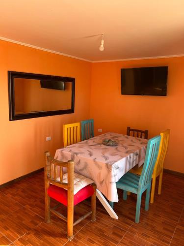 a dining room with a table and four chairs at Cabaña La quebrada 2 in Coquimbo