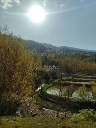 a view of a river from a hill at Hill View Resort in Shāhkot