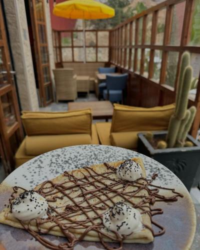 a plate with a dessert on a table at Playa Surf House in Tamraght Ouzdar