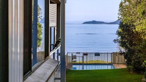 a window of a house with a view of the water at Bangalee 2 at Sunrise in Soldiers Point